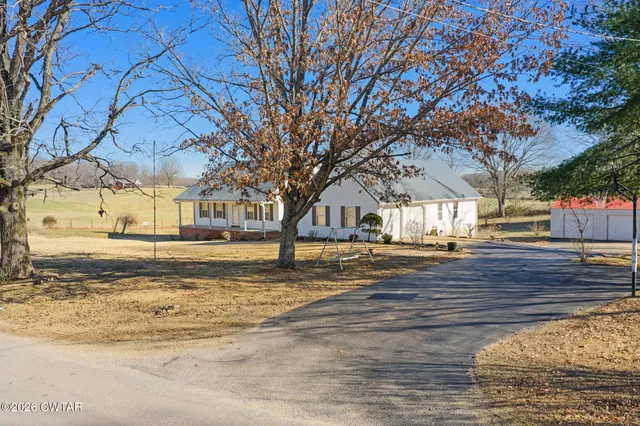 a large kitchen with a stove top oven sink and cabinets
