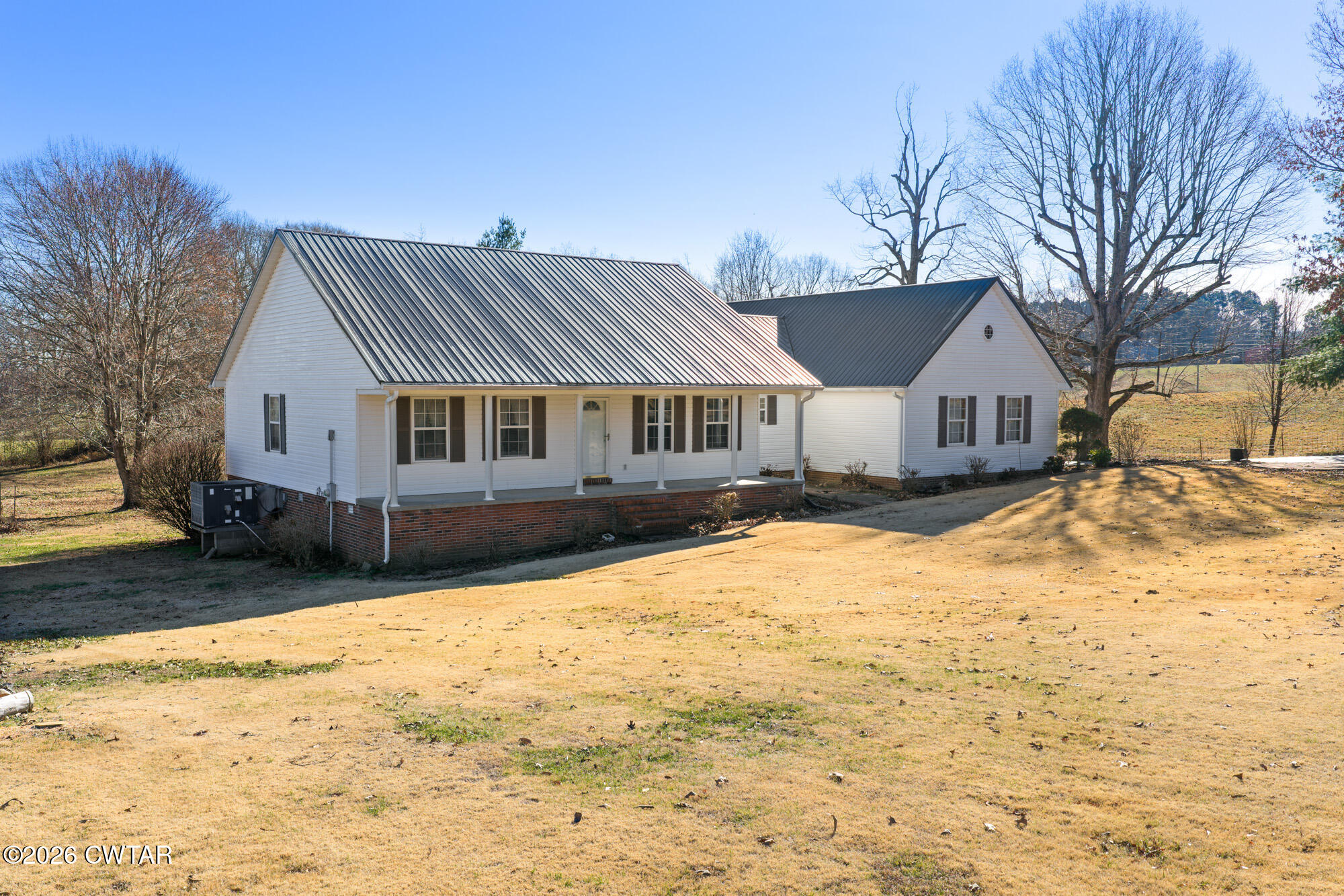 3149 Sand Ridge Road Lexington, TN 38351 - Photo 18 of 40 a front view of a house with a yard covered in snow