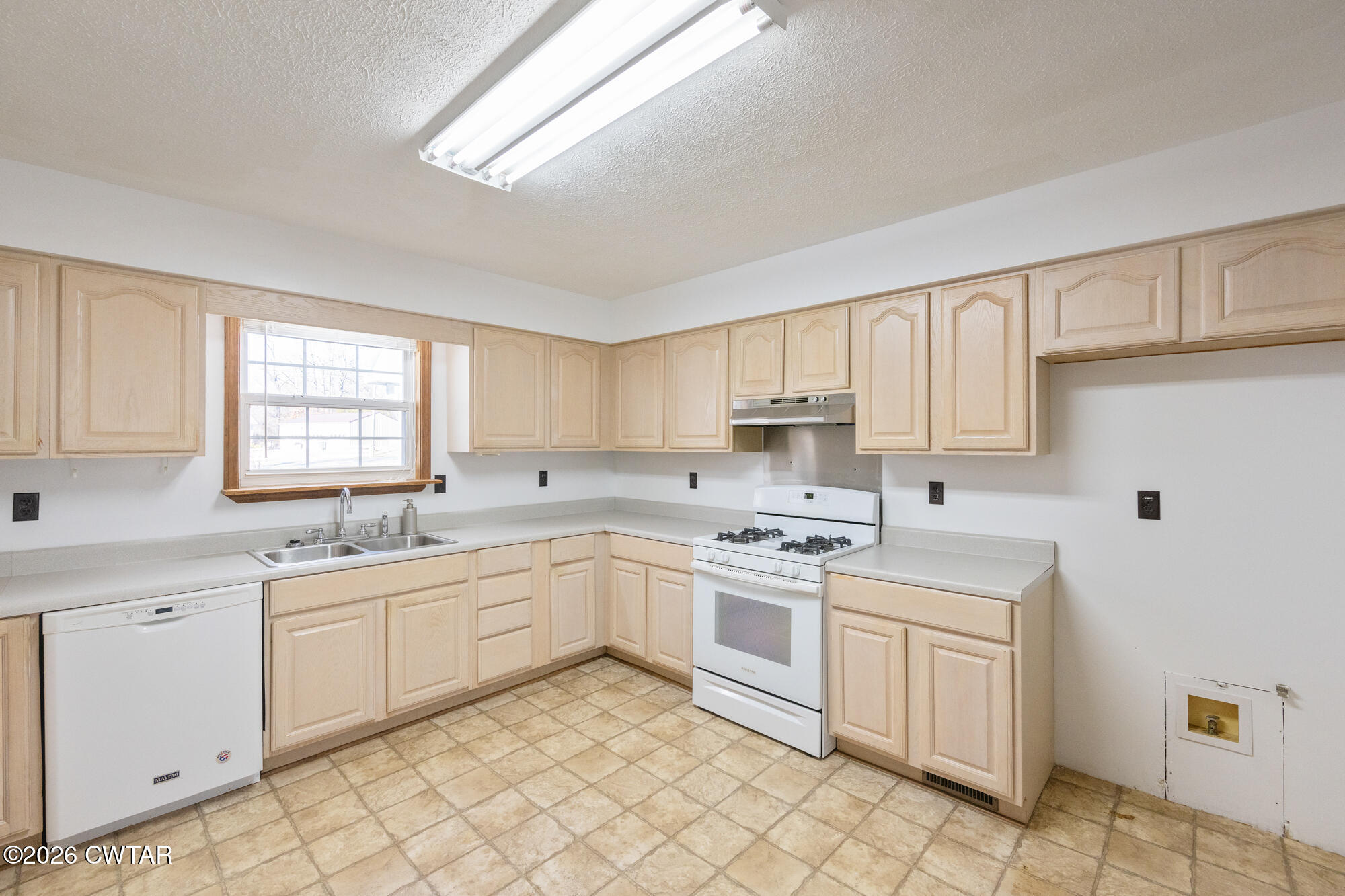 3149 Sand Ridge Road Lexington, TN 38351 - Photo 20 of 40 a kitchen with white cabinets sink and appliances