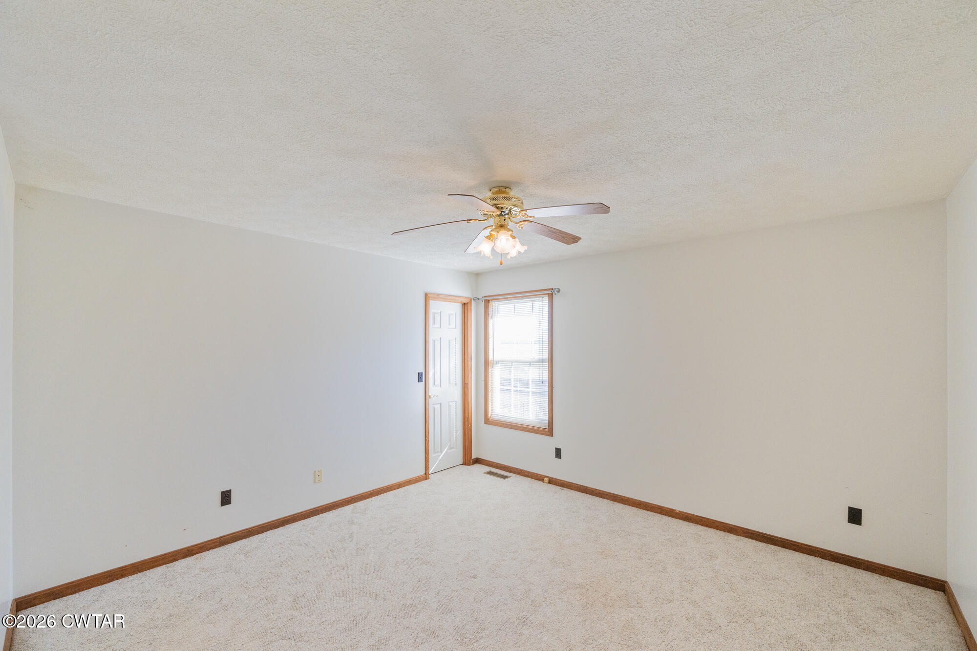 3149 Sand Ridge Road Lexington, TN 38351 - Photo 30 of 40 an empty room with chandelier fan and windows