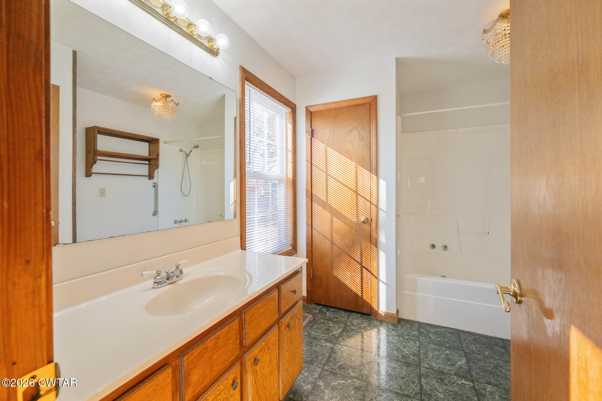 3149 Sand Ridge Road Lexington, TN 38351 - Photo 35 of 40 a bathroom with a tub sink and mirror