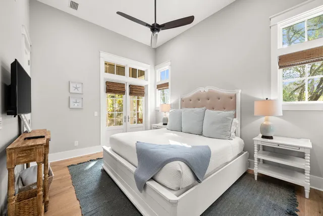 a bedroom with a bed and a flat tv screen on dresser