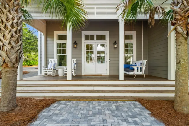 a view of a house with a patio and a yard