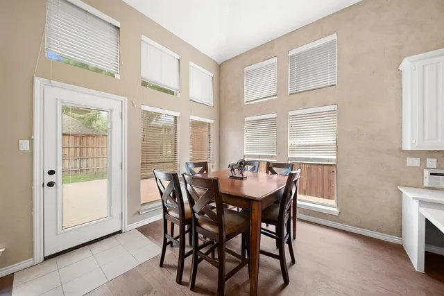 a view of a dining room with furniture and a window