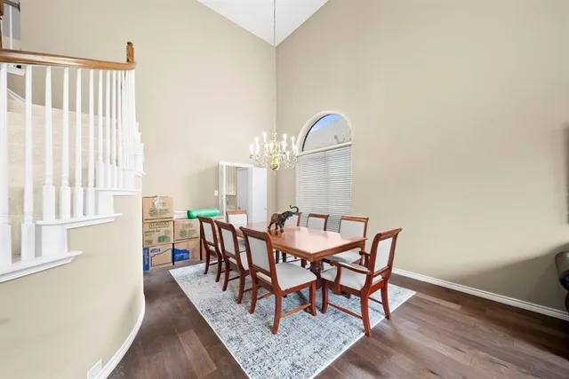 a dining room with furniture and wooden floor