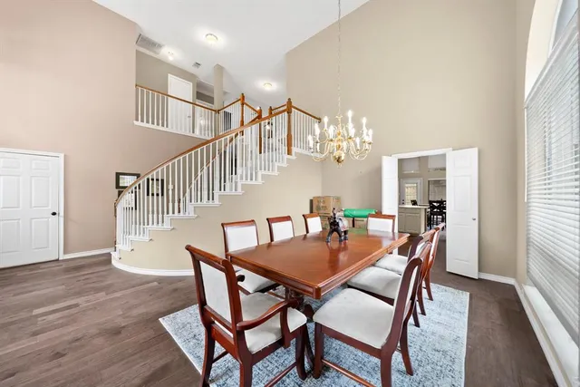a dining room with furniture and wooden floor
