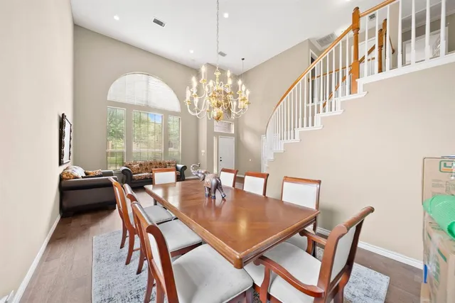 a view of a dining room with furniture and chandelier