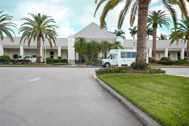 a front view of multiple houses with yard and green space