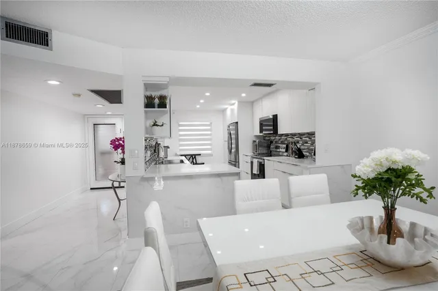 a living room with furniture and flowers