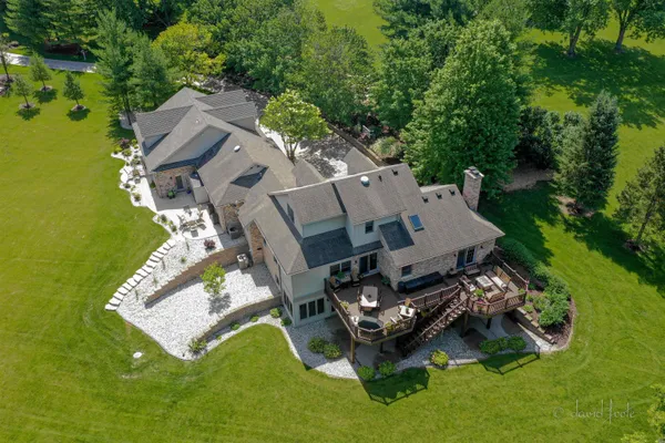 an aerial view of a house with a garden and swimming pool