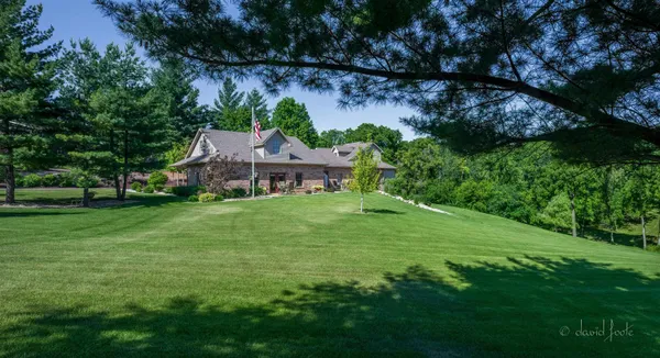 a bathroom with a granite countertop double vanity sink and a mirror