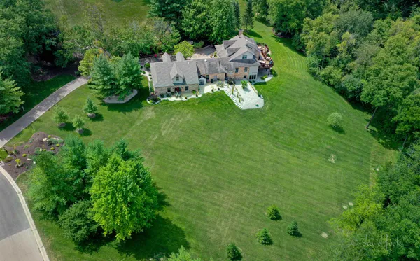 an aerial view of a house with a yard