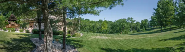 a front view of house with yard and green space