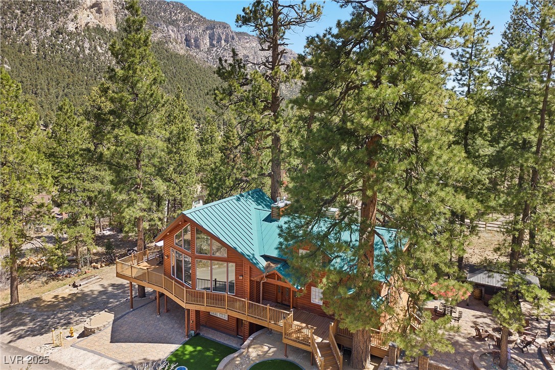 274 Ski Trail Road Mount Charleston, NV 89124 - Photo 2 of 75 Step outside onto a spacious deck offering stunning mountain/forest views.