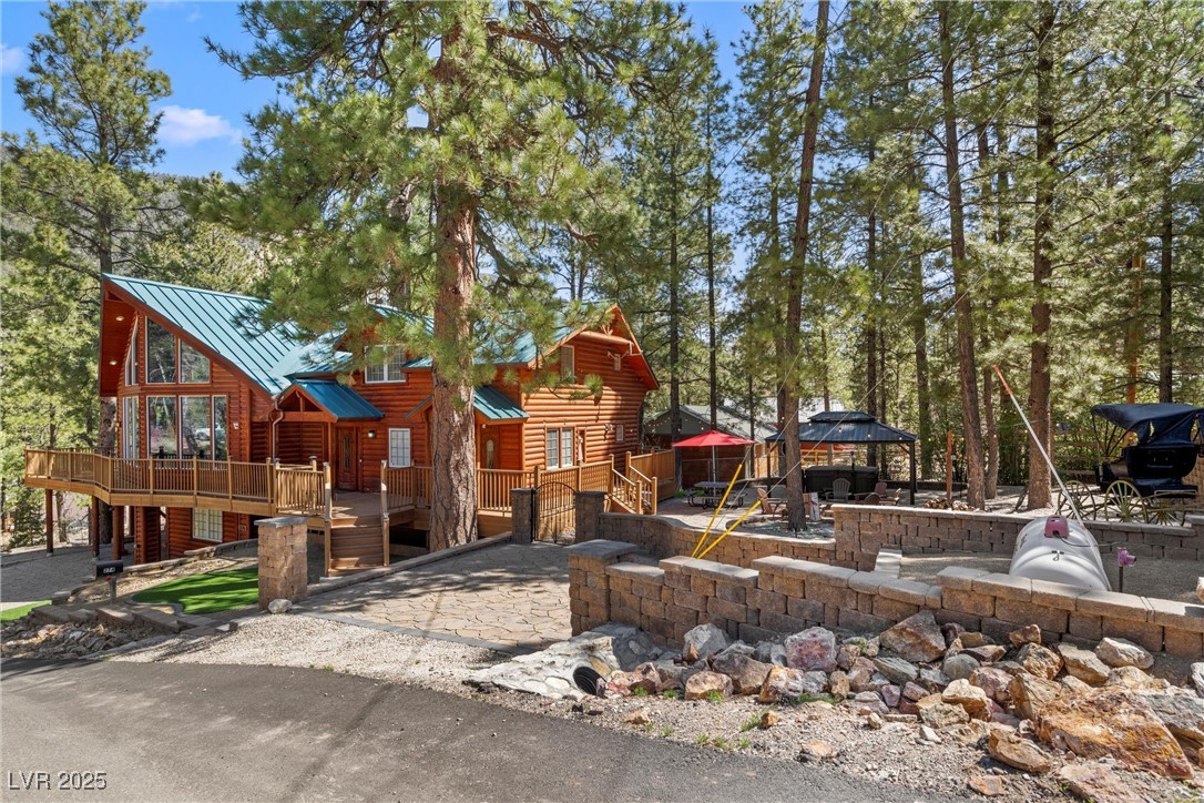 274 Ski Trail Road Mount Charleston, NV 89124 - Photo 4 of 75 Soak in the spa under the pavilion, gather around the custom fire pit, or relax in the private yard w/pavers, turf + bistro lights.