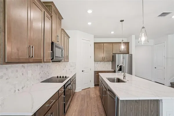 a kitchen with a sink stove and refrigerator