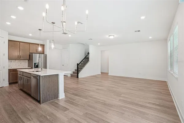a kitchen with a stove and a wooden floor
