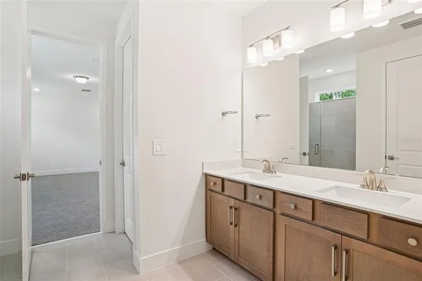 a bathroom with a double vanity sink and mirror