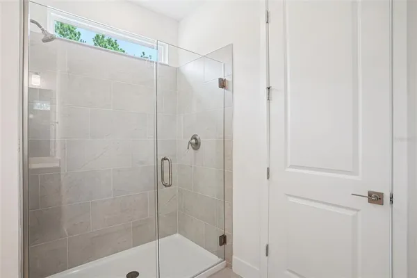 a bathroom with a shower and a sink