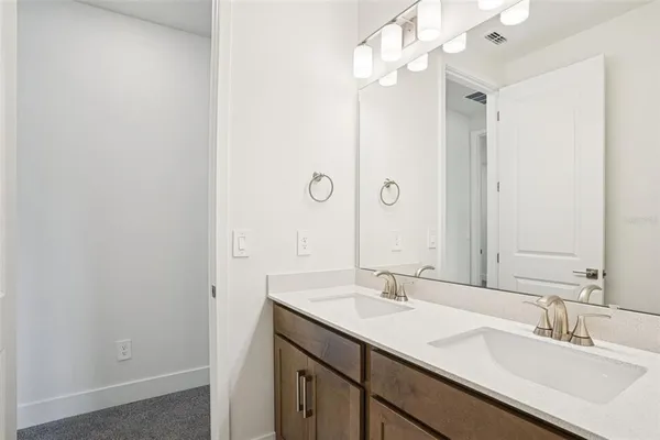 a bathroom with a sink vanity and a mirror