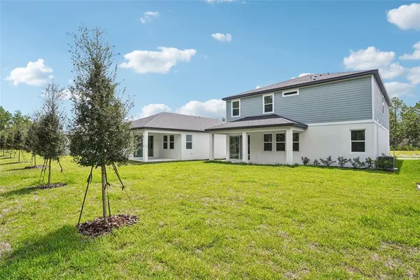 a view of a house with pool and garden