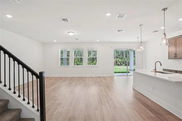 a view of kitchen with sink and wooden floor