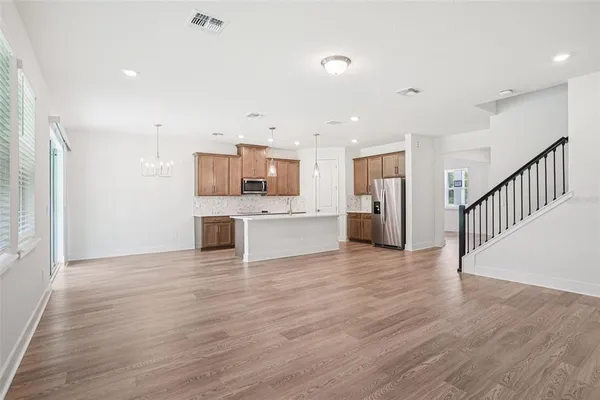 a view of a kitchen with a sink and a refrigerator