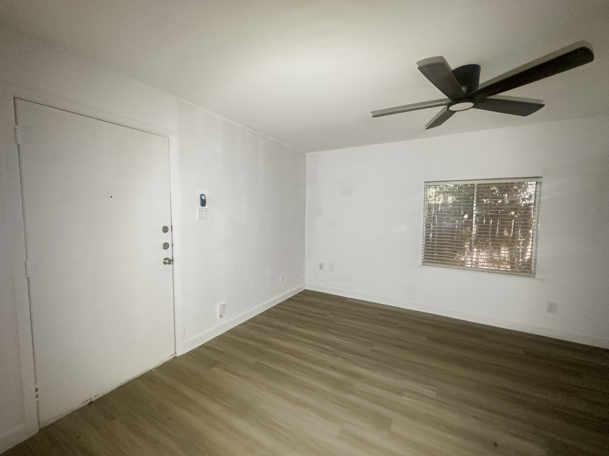 4500 Witham Lane, Unit 204 Austin, TX 78745 - Photo 1 of 1 a view of an empty room with wooden floor and a ceiling fan