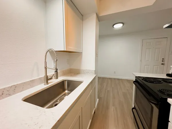 a kitchen that has a sink and a stove