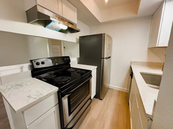 a kitchen with a stove microwave and refrigerator