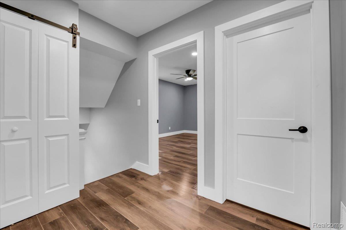 2181 Harding Street Detroit, MI 48214 - Photo 22 of 32 Hallway featuring dark wood-type flooring and a barn door