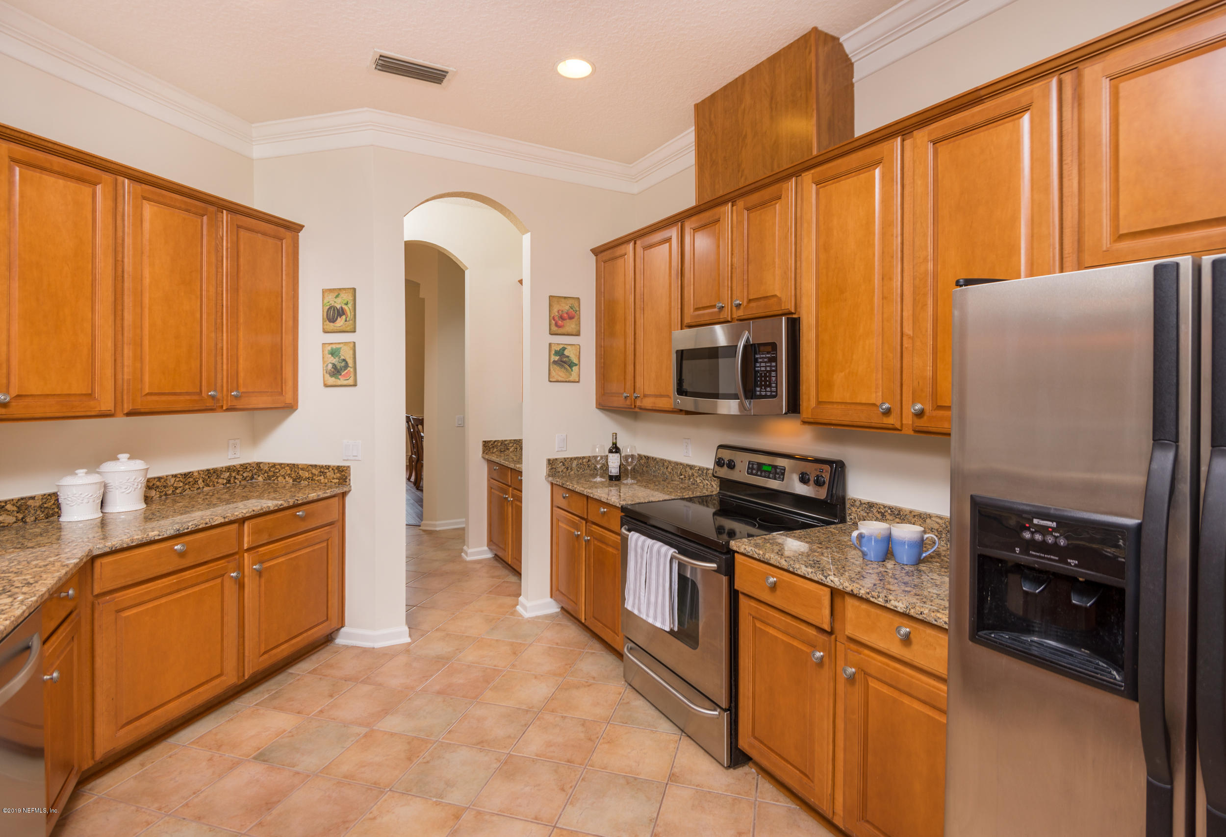 800 Riley Lane St. Augustine, FL 32095 - Photo 17 of 88 a kitchen with stainless steel appliances granite countertop a refrigerator stove top oven and sink
