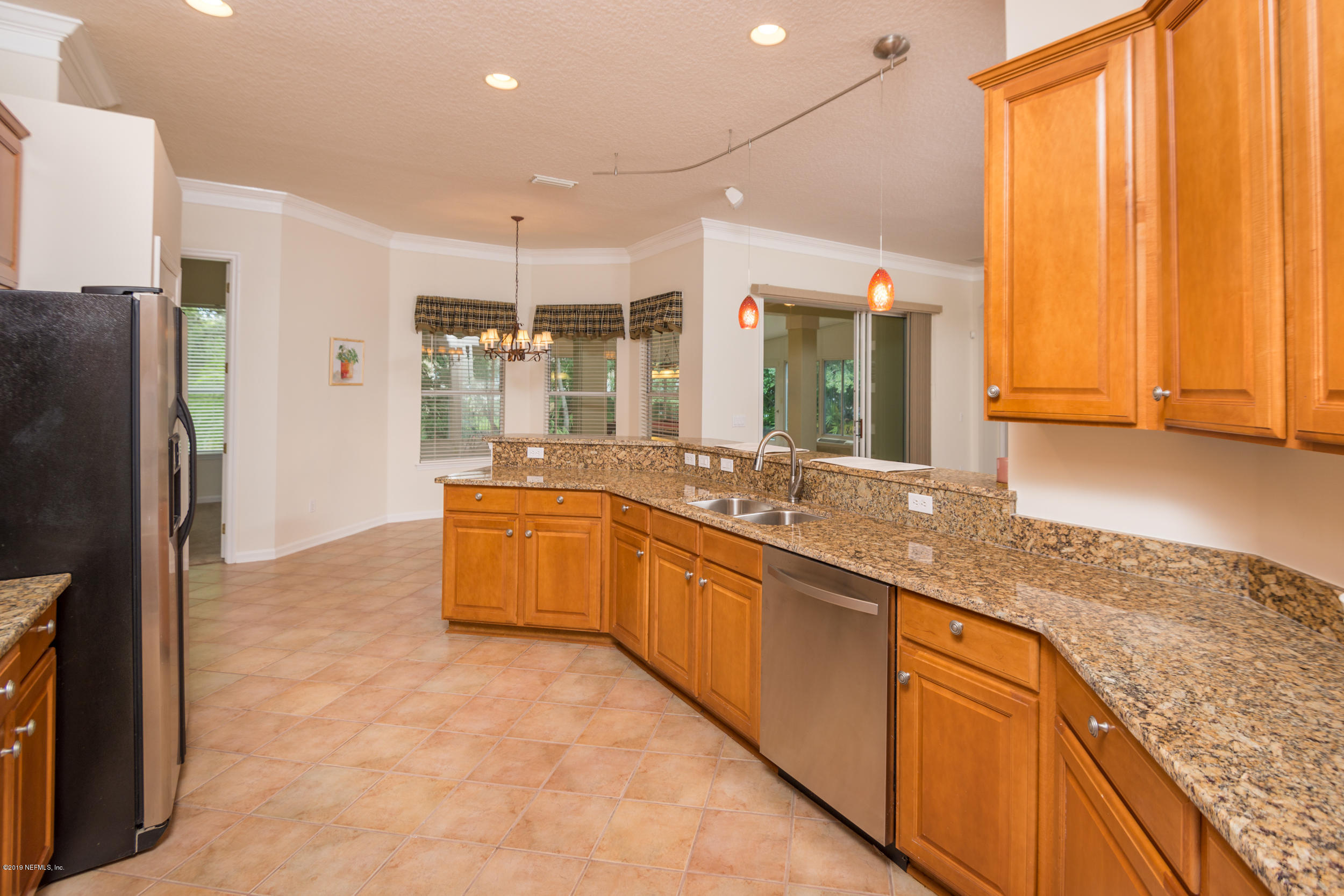 800 Riley Lane St. Augustine, FL 32095 - Photo 19 of 88 a large kitchen with kitchen island granite countertop a sink and refrigerator