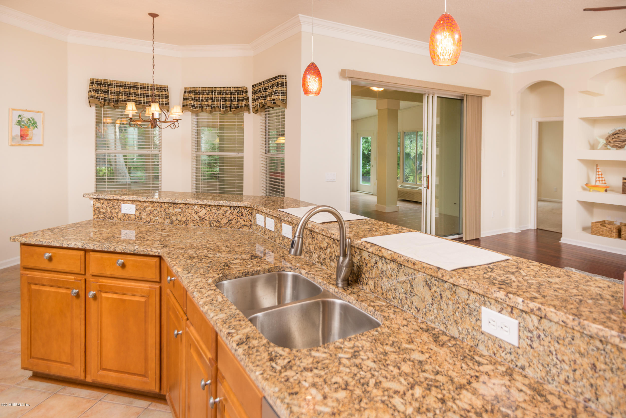 800 Riley Lane St. Augustine, FL 32095 - Photo 20 of 88 a kitchen with granite countertop a sink and dishwasher with wooden floor