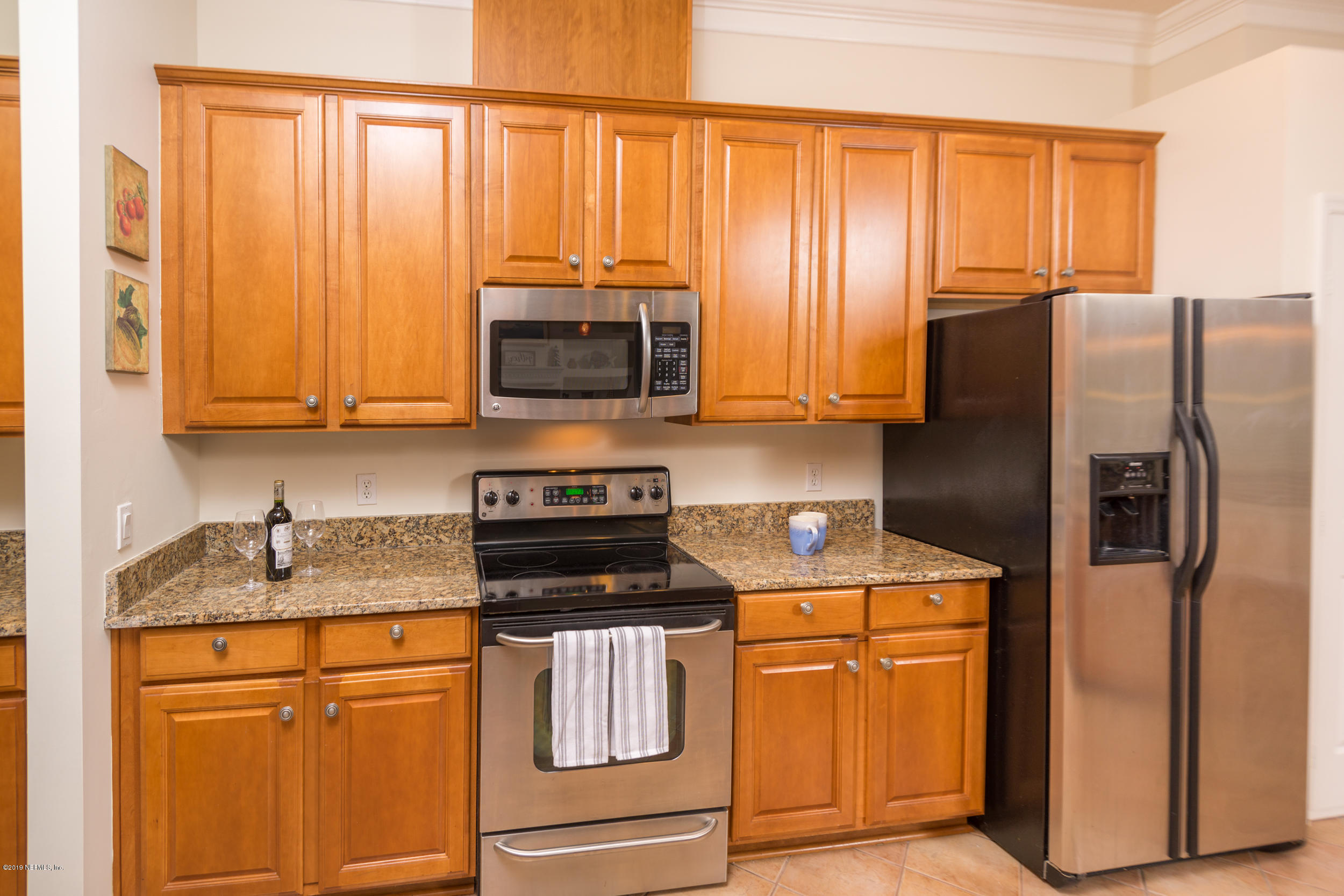 800 Riley Lane St. Augustine, FL 32095 - Photo 21 of 88 a kitchen with stainless steel appliances granite countertop a refrigerator stove and microwave