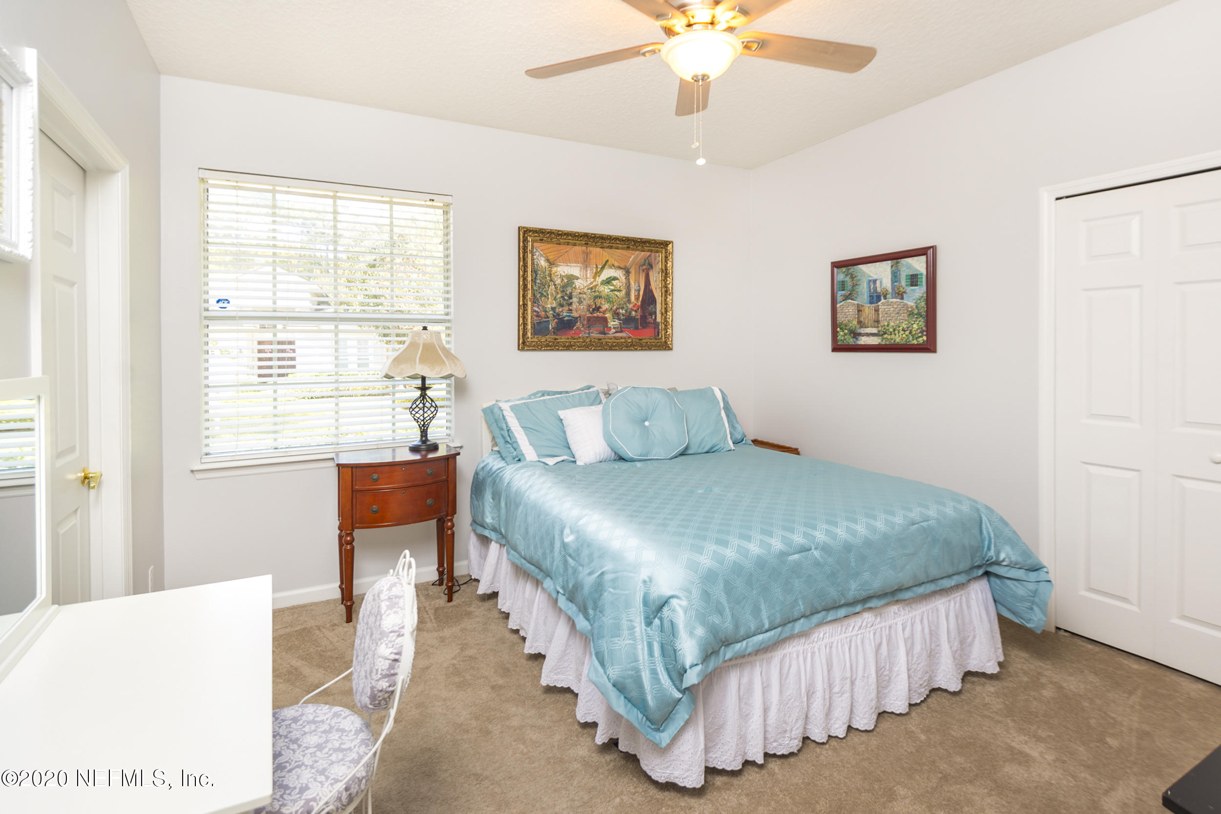 800 Riley Lane St. Augustine, FL 32095 - Photo 35 of 88 a bedroom with a bed and a chandelier