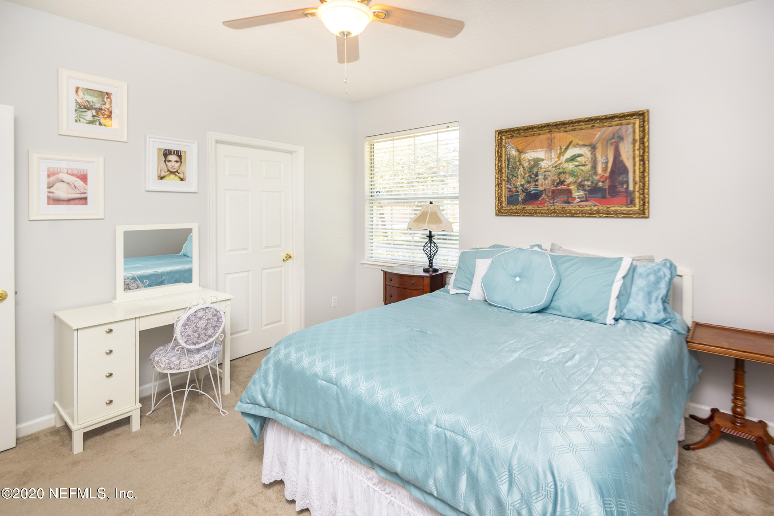 800 Riley Lane St. Augustine, FL 32095 - Photo 36 of 88 a bedroom with a bed and a chandelier