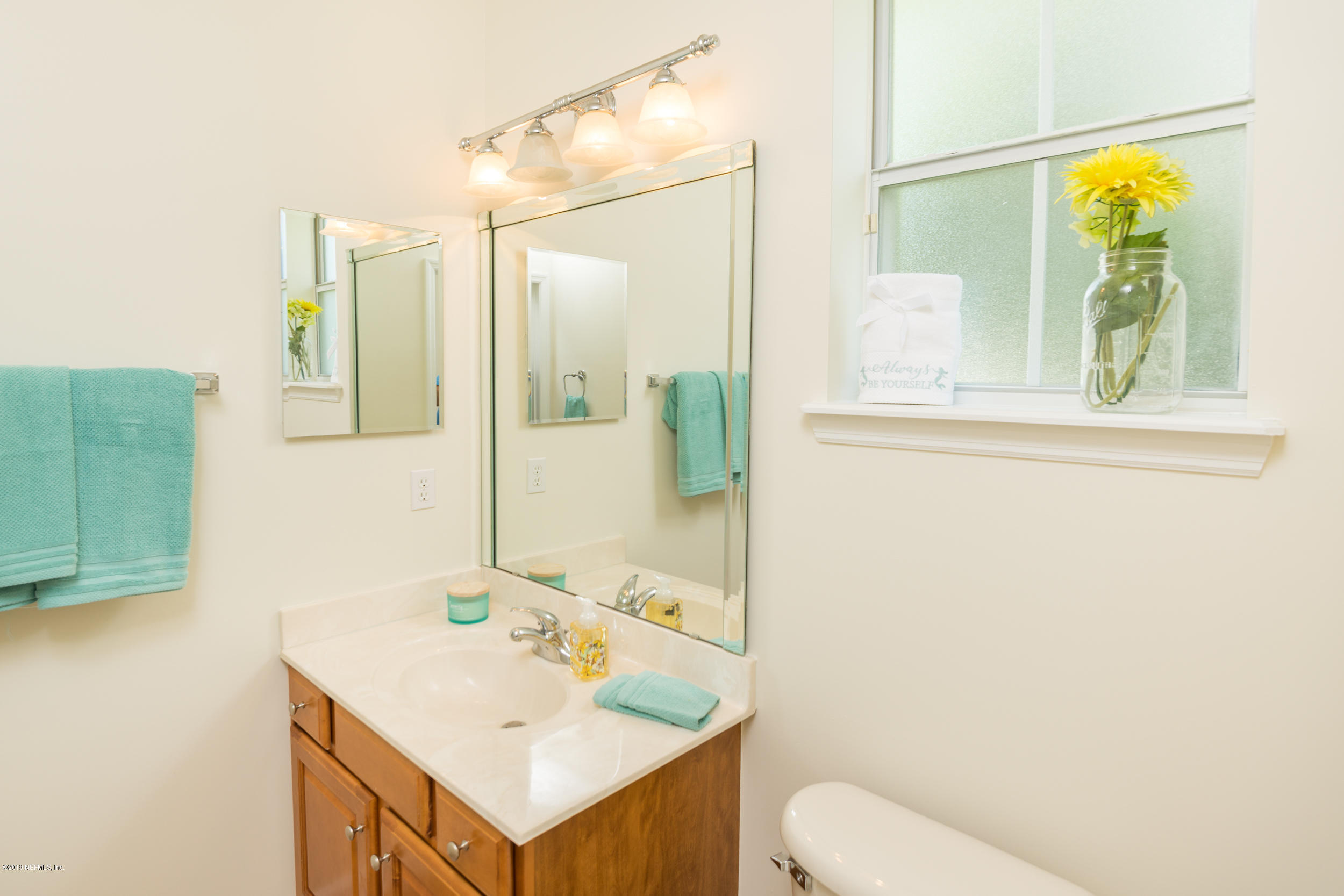 800 Riley Lane St. Augustine, FL 32095 - Photo 43 of 88 a bathroom with a sink and mirror with toilet