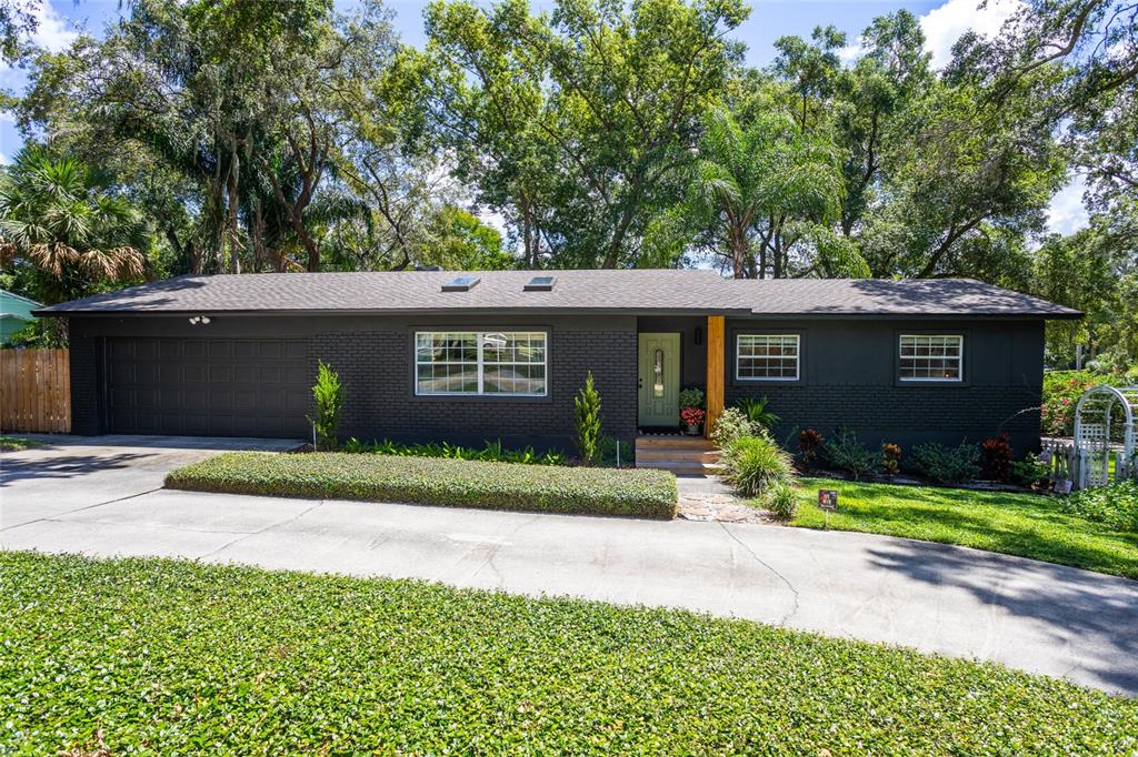 2209 Good Homes Road Orlando, FL 32818 - Photo 1 of 1 a front view of a house with a yard and a garage