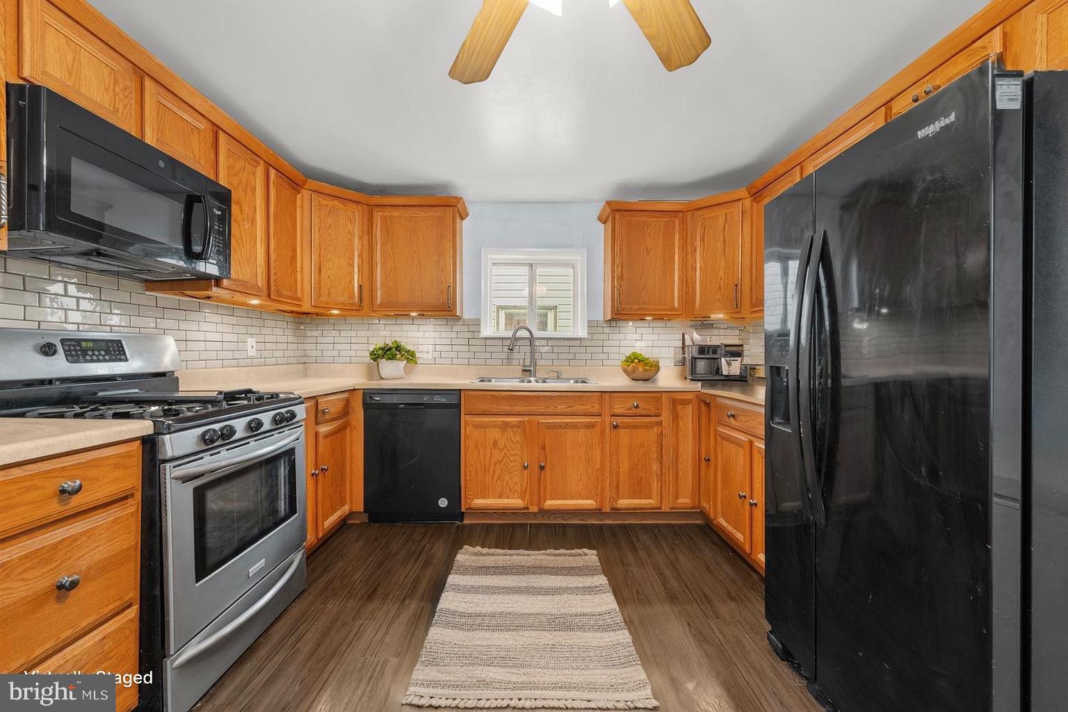 578 Swain Street Bristol, PA 19007 - Photo 4 of 17 a kitchen with stainless steel appliances granite countertop a stove a sink and a refrigerator