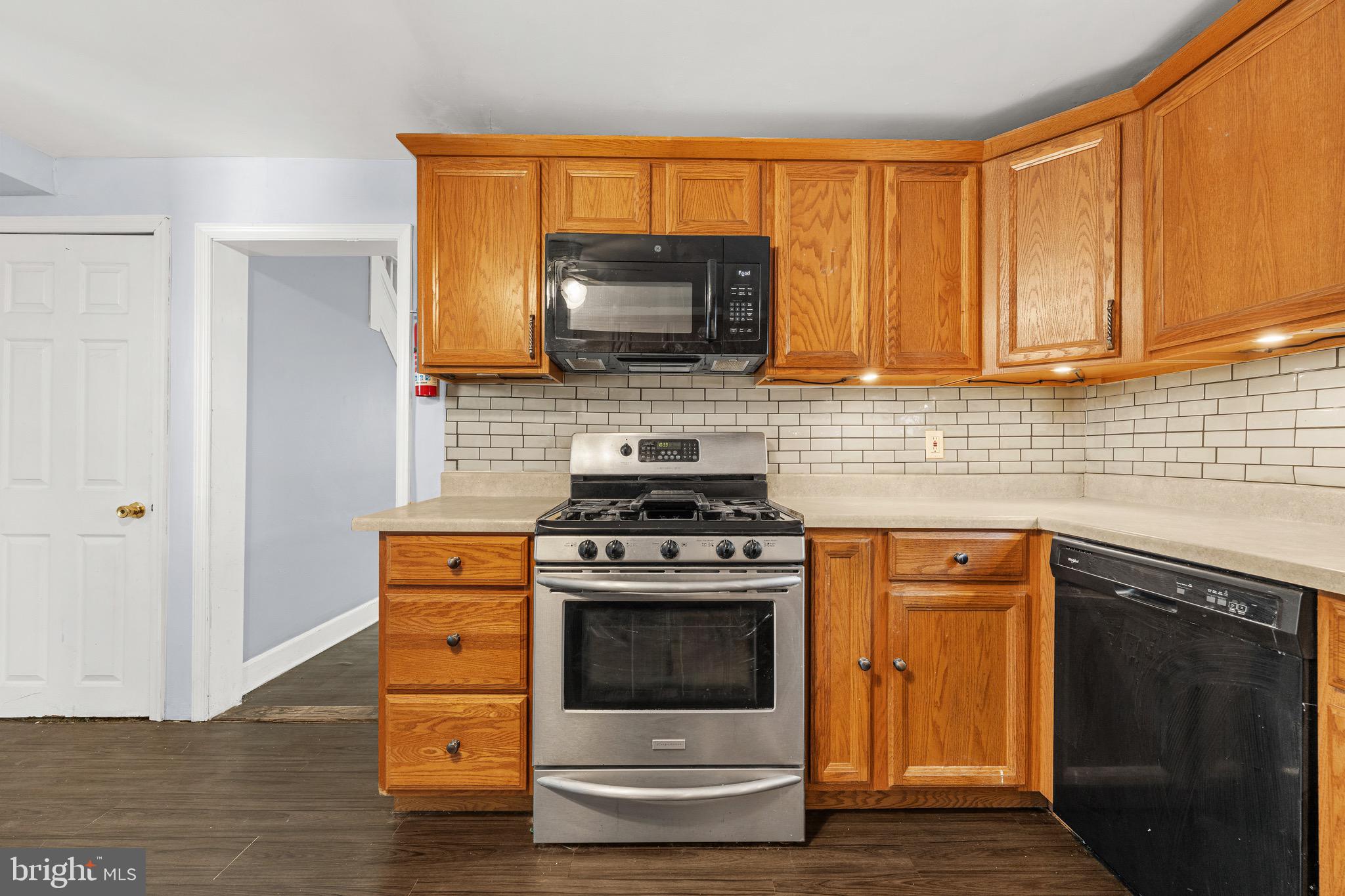 578 Swain Street Bristol, PA 19007 - Photo 5 of 17 a kitchen with a stove and a microwave