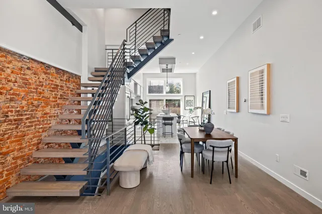 a living room with furniture potted plant and a mirror