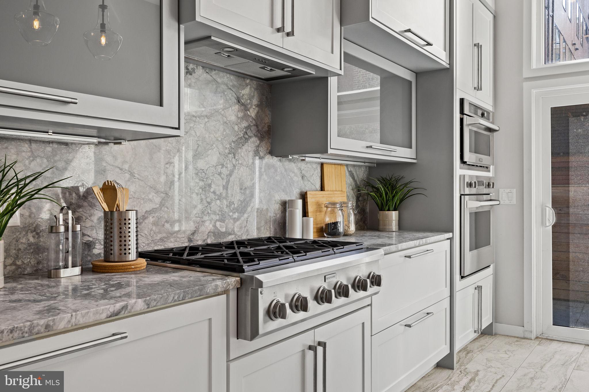 2106 Spring Street Philadelphia, PA 19103 - Photo 18 of 68 a kitchen with stainless steel appliances granite countertop a sink stove and cabinets