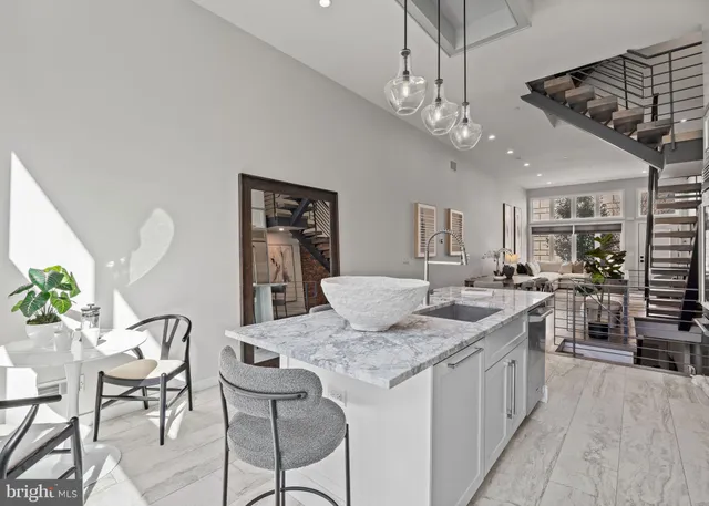 a bedroom with a bed mirror and couch