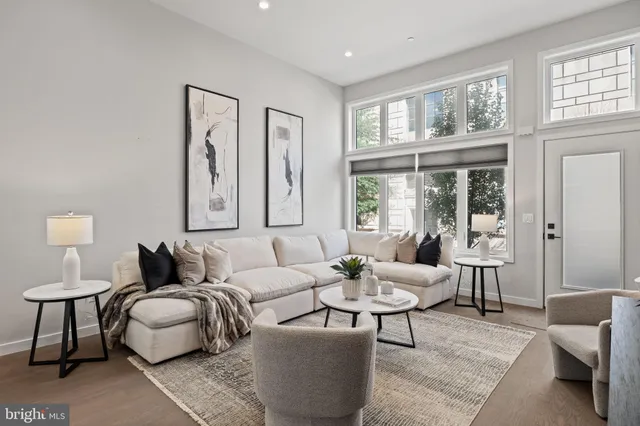 a dining room with furniture window and wooden floor