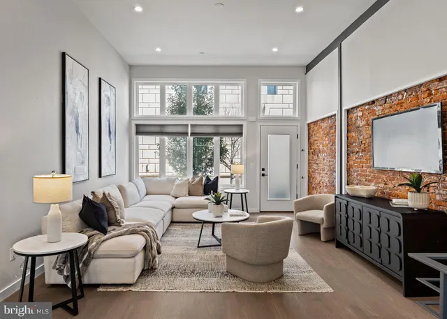 a kitchen with stainless steel appliances a dining table chairs stove and refrigerator