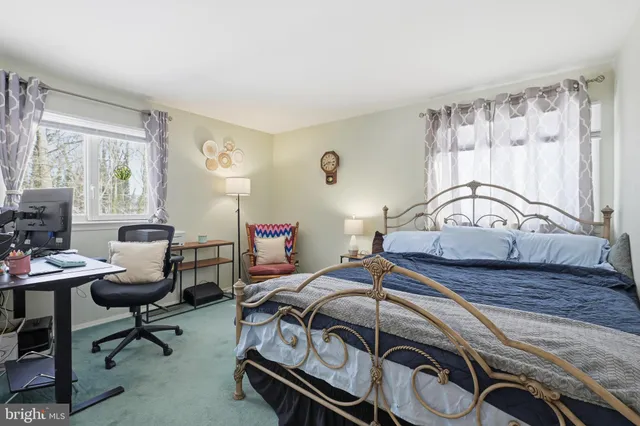 a bedroom with a bed a table and a chair