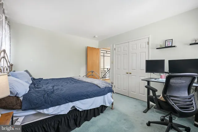a bedroom with a bed and a desk