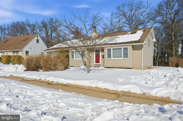 a view of a house with snow on the road