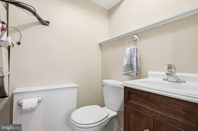 a bathroom with a sink a toilet and vanity